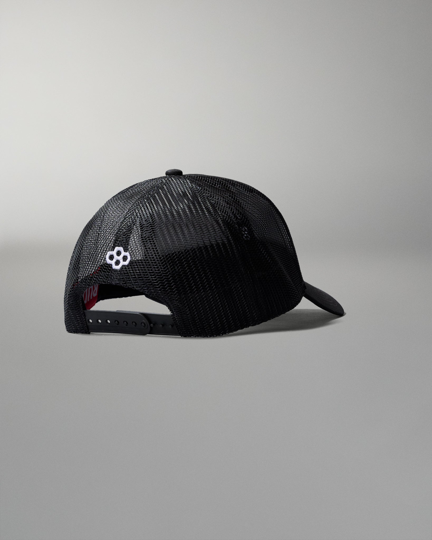 Black mesh cap with a logo on a gray background