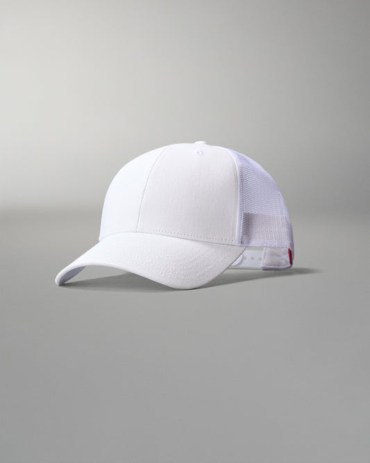 White cap with mesh back on a gray background