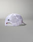White mesh cap with a small logo on a gray background