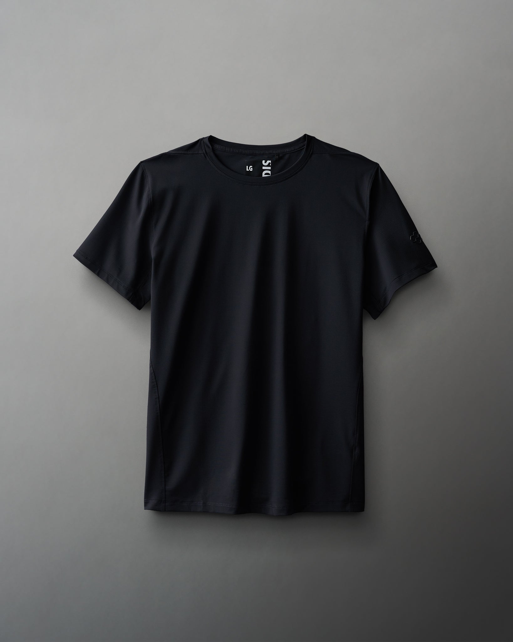 A black textured waffle material t-shirt displayed against a neutral background.