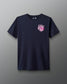 Front view of a navy T-shirt with a small white and pink graphic on the left chest that reads ‘A Way of Life’ in stylized overlapping text. 