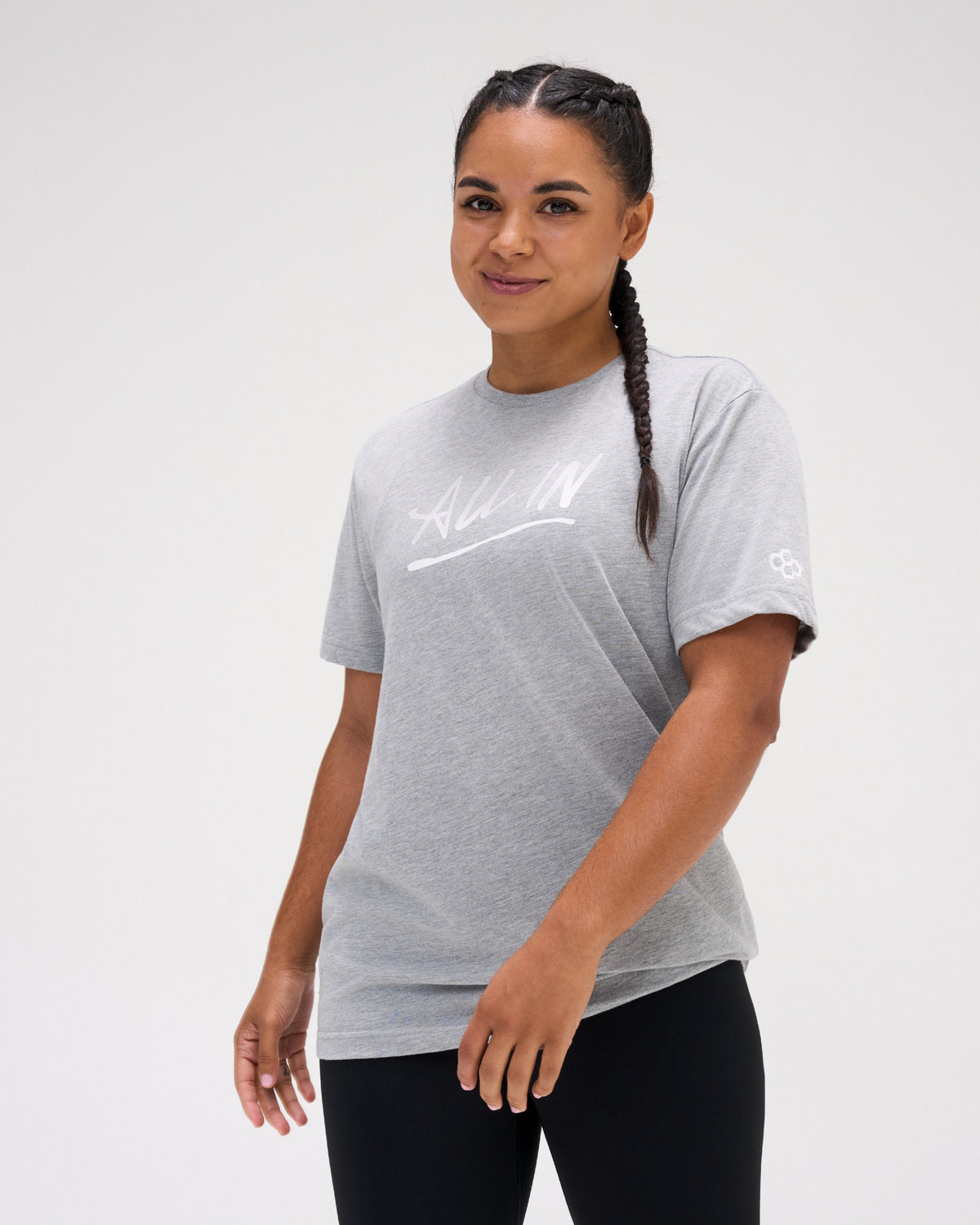 Female athlete wearing the gray RUDIS Motto Scripted Elite Super Soft T-Shirt featuring a white All In chest graphic.