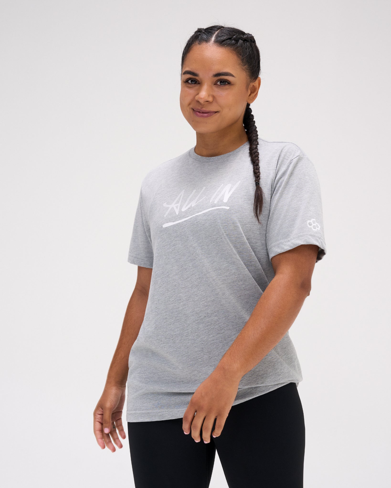 Female athlete wearing the gray RUDIS Motto Scripted Elite Super Soft T-Shirt featuring a white All In chest graphic.