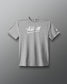 A heather gray short-sleeve t-shirt with 'All In' printed in white script across the chest, displayed against a dark gray gradient background.