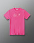 A bright pink short-sleeve t-shirt with 'All In' printed in white script across the chest, displayed flat against a dark gray gradient background.