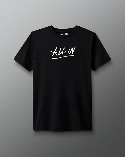 Front view of a black T-shirt with the phrase ‘ALL IN’ printed in bold white handwritten-style lettering across the chest, with an underline.
