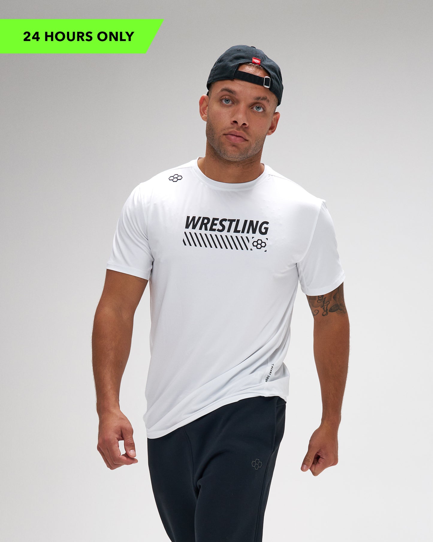 Man wearing a white 'Wrestling' t-shirt on a gray background