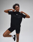 Person wearing a black athletic outfit with a logo on a gray background