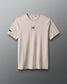 Beige t-shirt with a black logo on a gray background