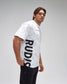 Man wearing a white t-shirt with 'RUDIS' logo on a gray background