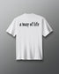 White t-shirt with 'a way of life' text on a gray background