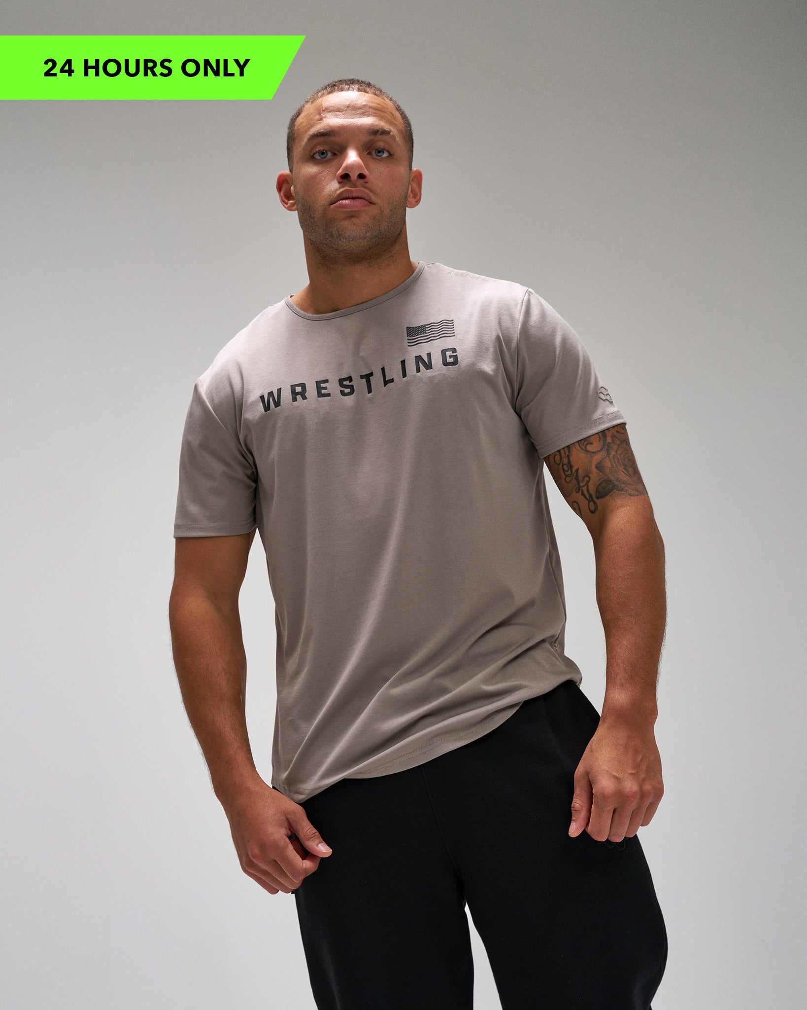 Man wearing a gray 'Wrestling' t-shirt on a plain background