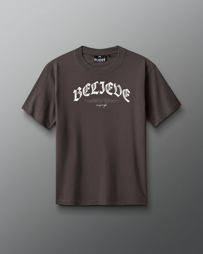 Brown t-shirt with 'BELIEVE' text on a gray background
