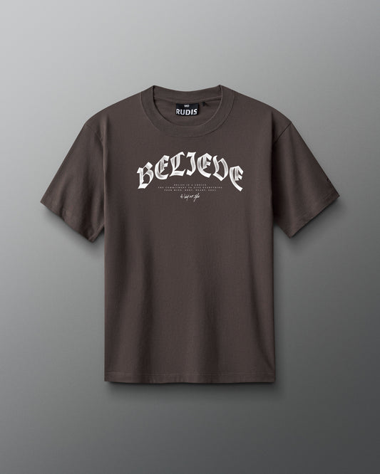 Brown t-shirt with 'BELIEVE' text on a gray background