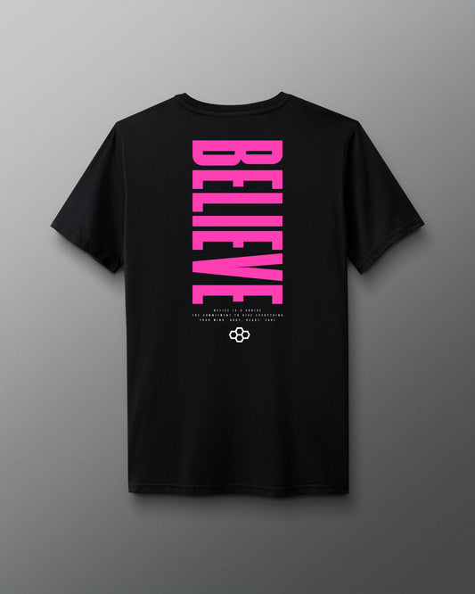 Black t-shirt with pink 'BELIEVE' text on a gray background