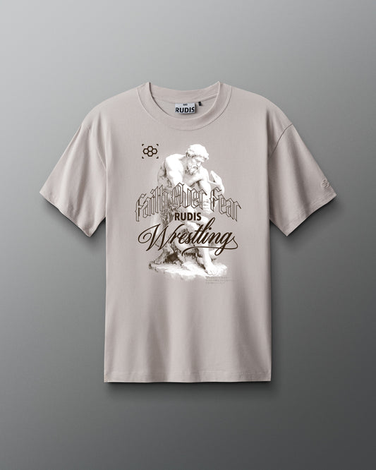 Beige faith over fear t-shirt with wrestling graphic and text on a gray background