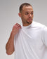 Man wearing a white t-shirt against a plain background