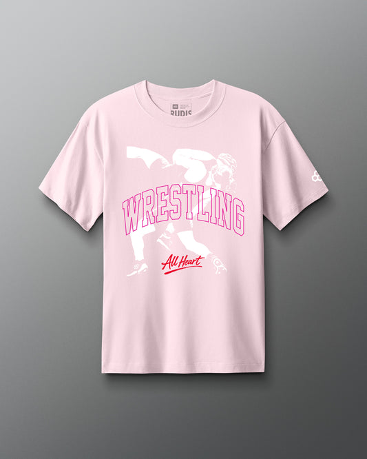 Pink t-shirt with wrestling graphic and text on a gray background