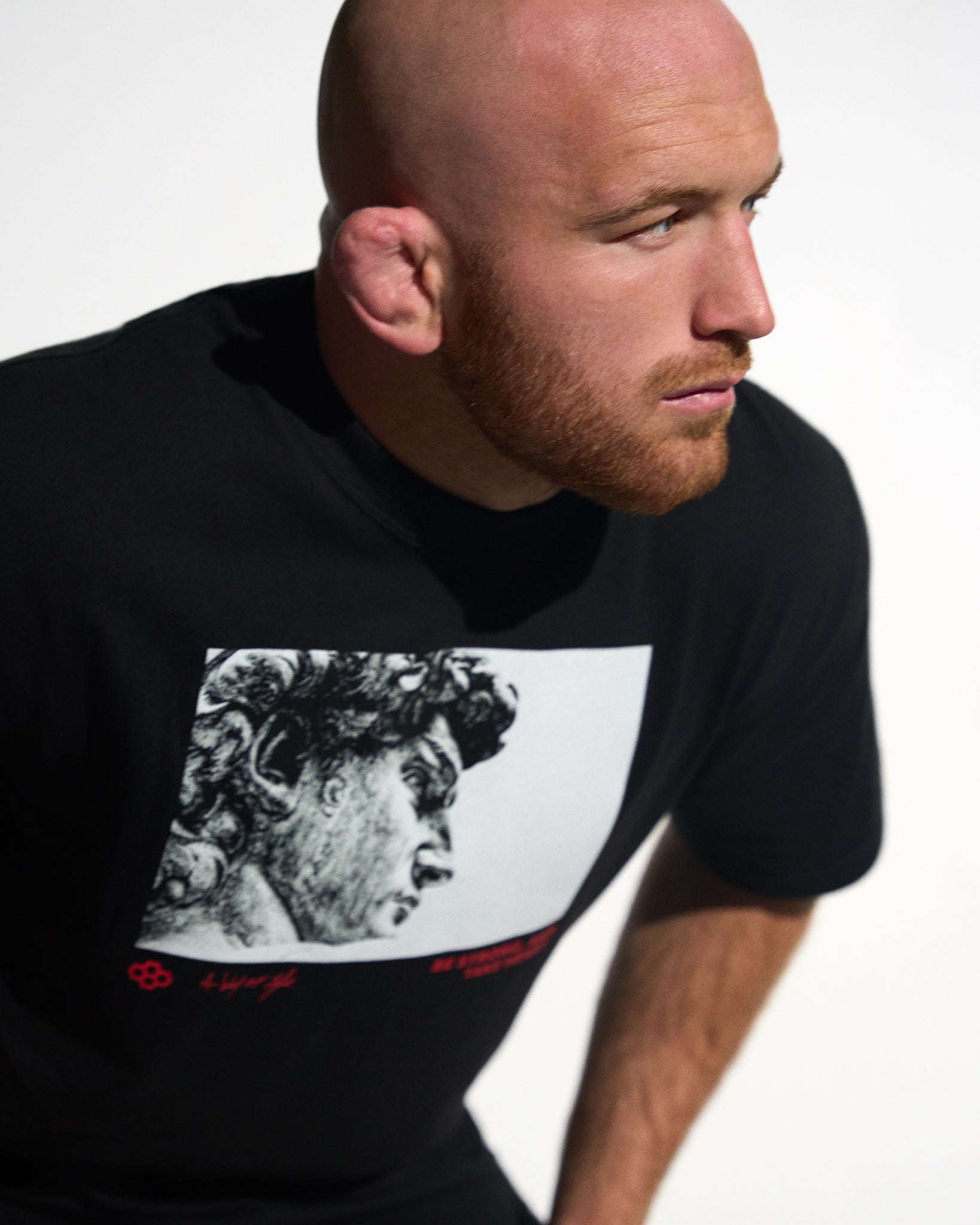Man wearing a black t-shirt with a graphic design on a white background