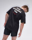 Person wearing a black t-shirt with 'Iron Sharpens Iron' text on the back against a white background