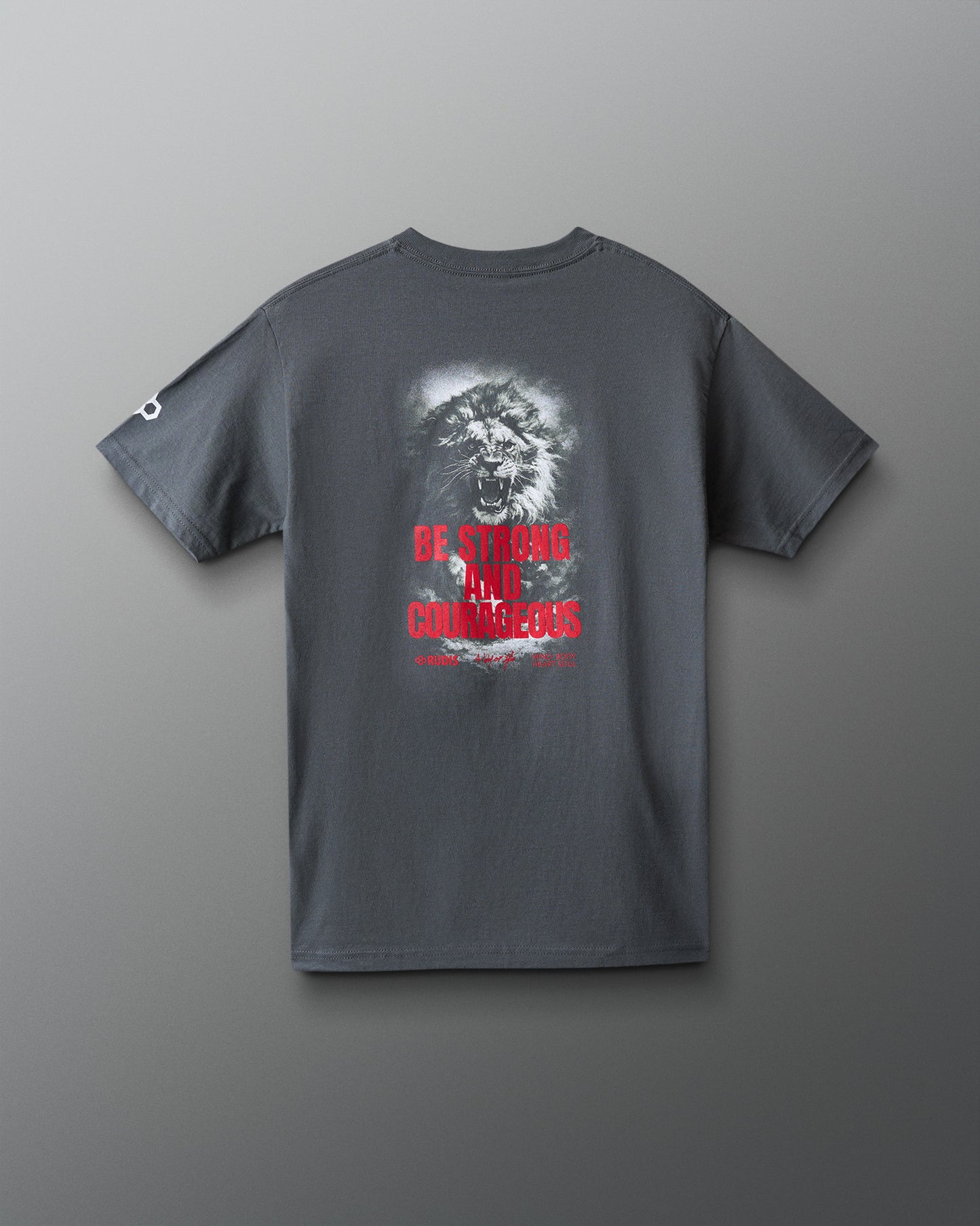 Gray t-shirt with a graphic design and 'Be strong and courageous' text on the back against a gray background
