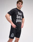 Man wearing a black t-shirt and shorts with 'fear has no power' text on a gray background