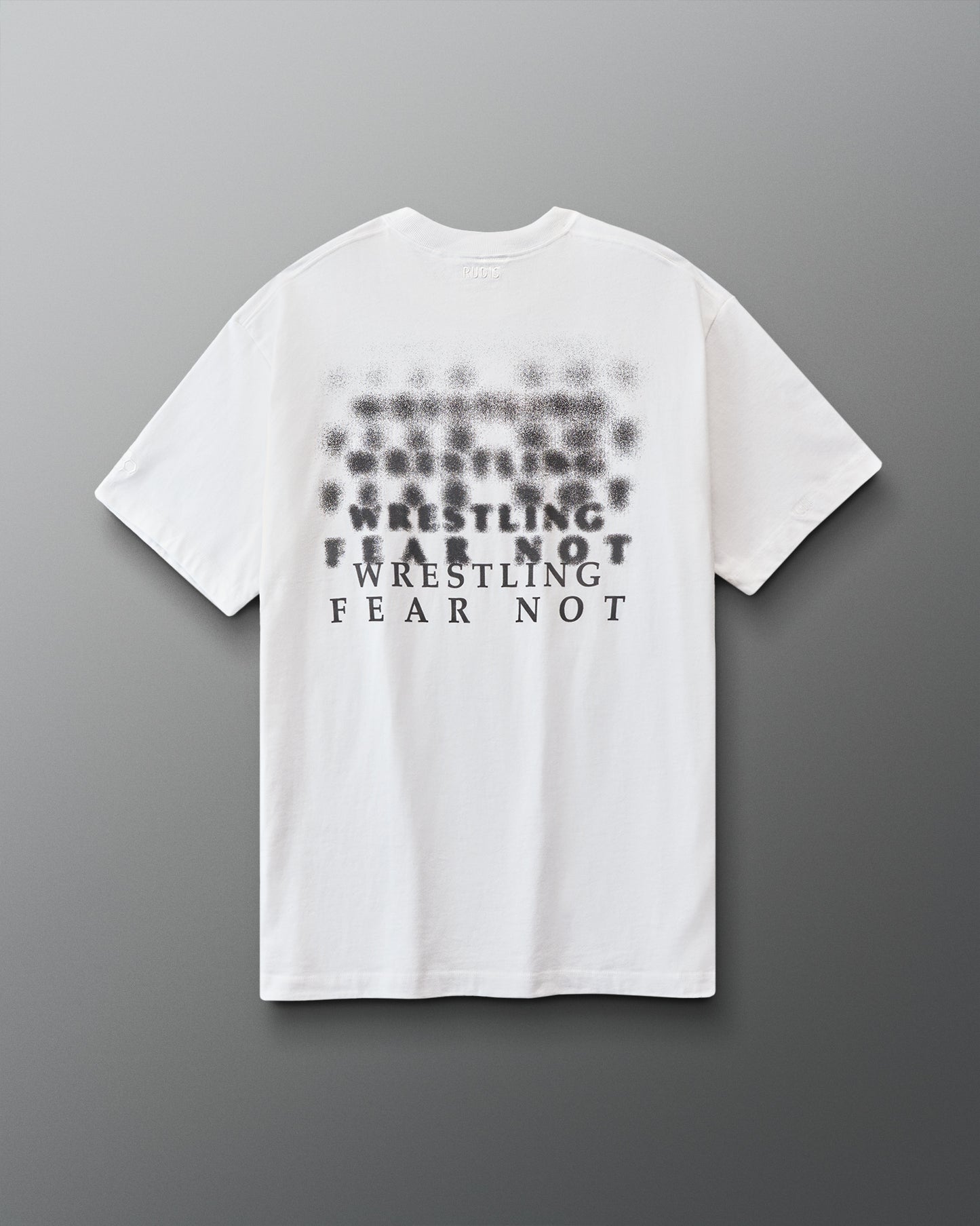 White t-shirt with black 'Wrestling fear not' text on a gray background