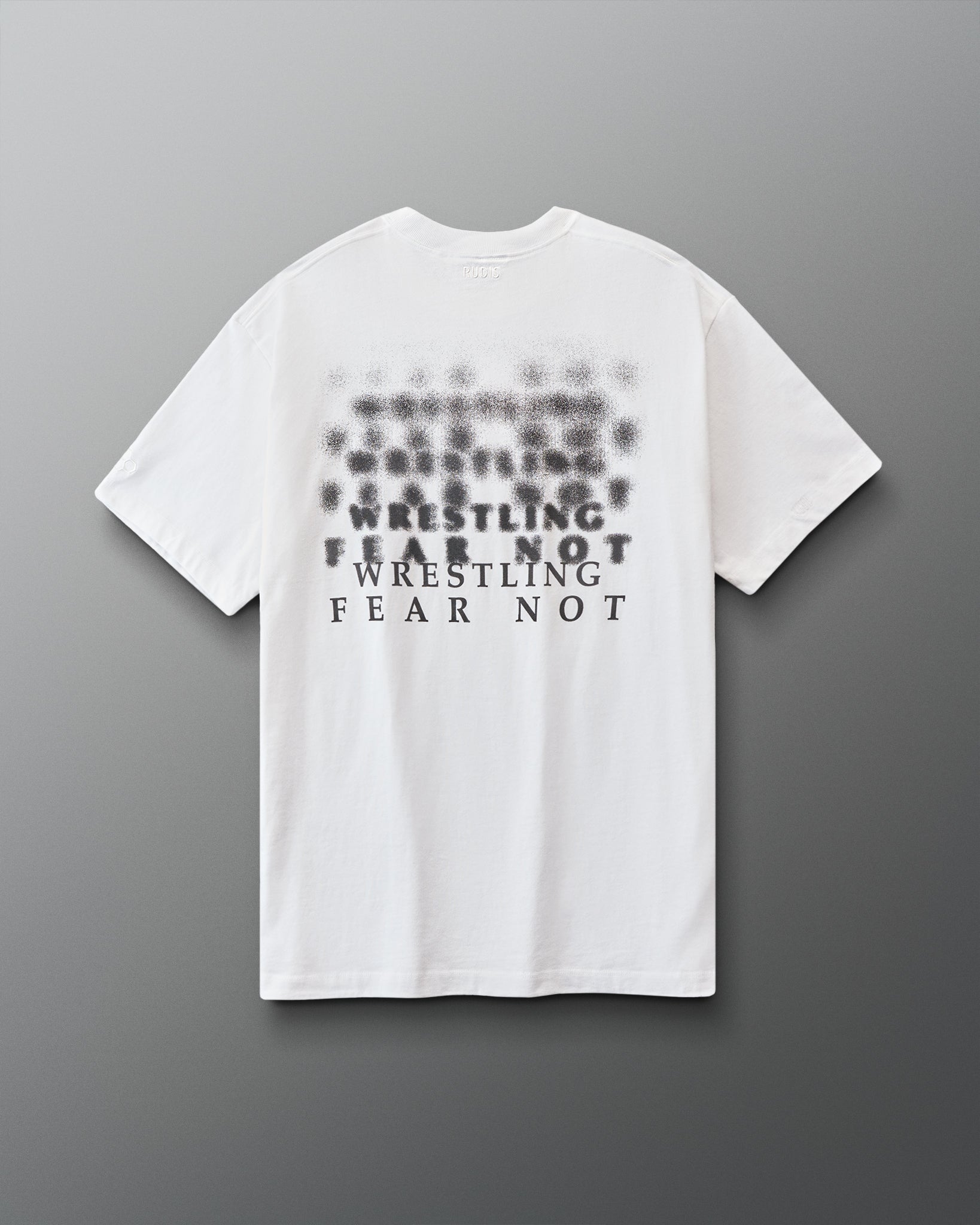 White t-shirt with black 'Wrestling fear not' text on a gray background