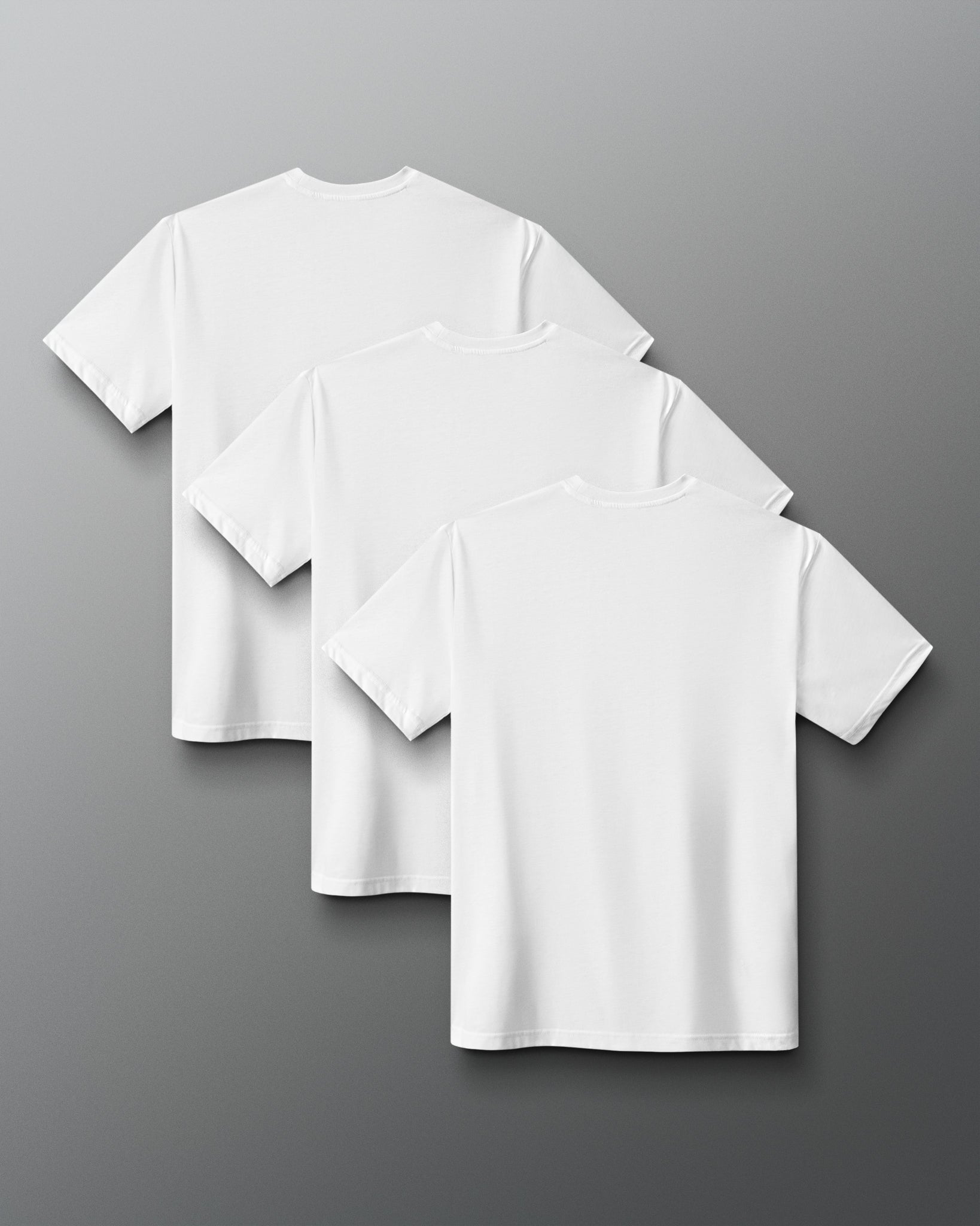 Three White short-sleeve crewneck t-shirts arranged in a cascading stack on a dark gray gradient background.