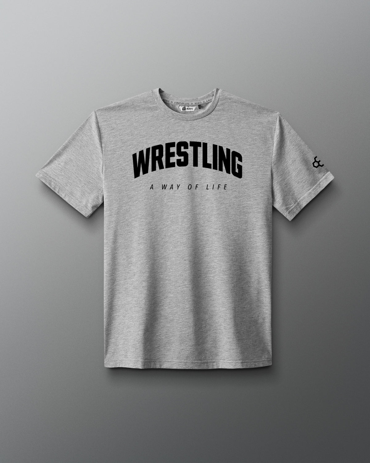 A light gray heather crewneck t-shirt featuring the word 'WRESTLING' in bold black arched letters across the chest, with 'A WAY OF LIFE' printed underneath in smaller text. A small black logo is visible on the left sleeve.