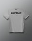 A heather gray short-sleeve t-shirt shown from the back, featuring the phrase 'A WAY OF LIFE' printed in bold black capital letters across the upper back. The brand name 'RUDIS' is visible in small black text inside the back collar.