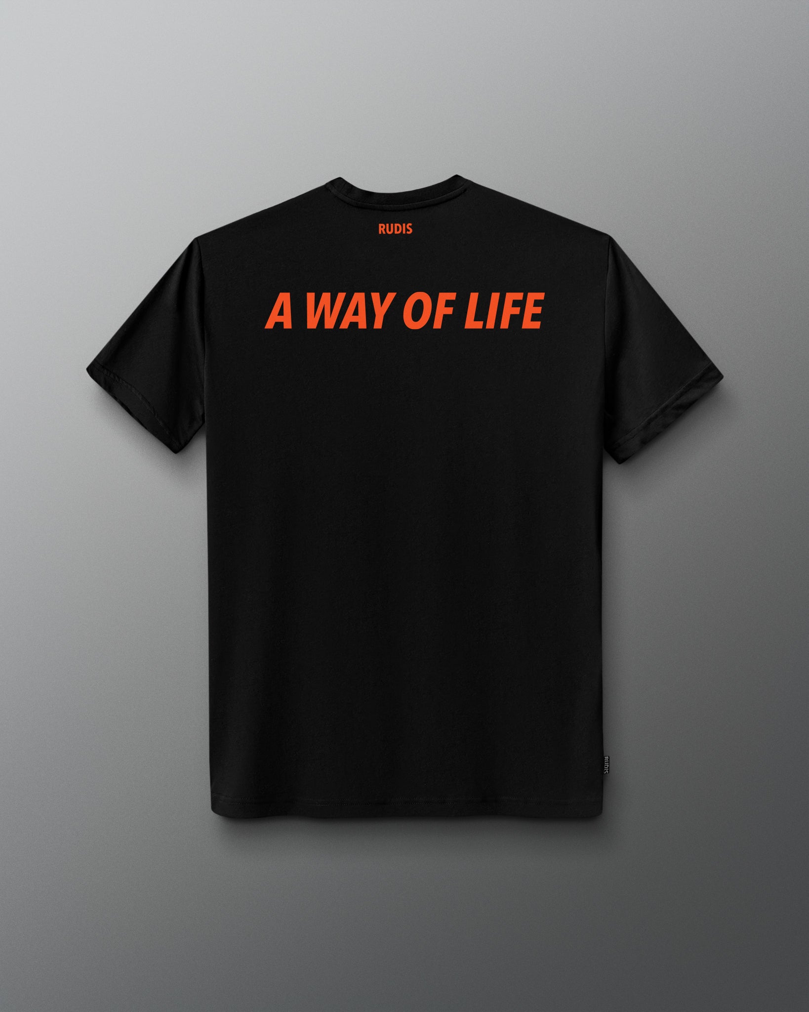 A black short-sleeve t-shirt shown from the back, featuring the phrase 'A WAY OF LIFE' printed in bold orange letters across the upper back. The brand name 'RUDIS' is printed in small orange letters below the collar.