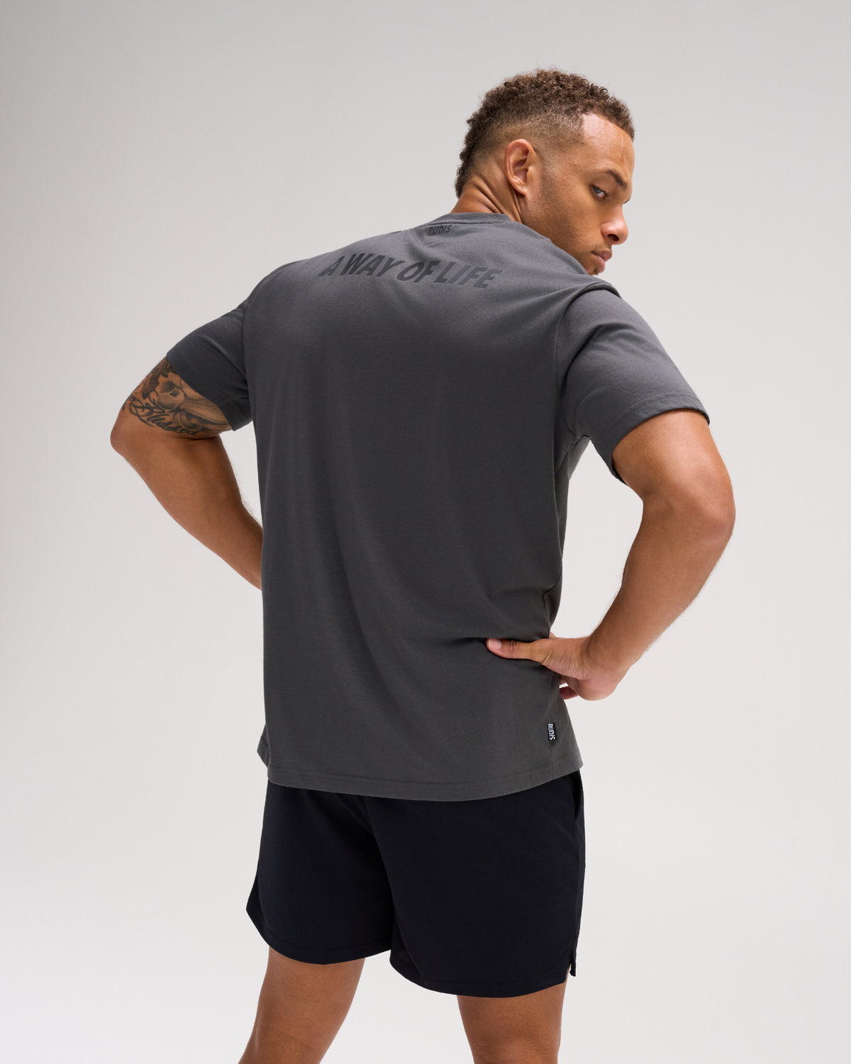 Back view of the charcoal RUDIS Script Elite Super Soft T-Shirt featuring tonal A WAY OF LIFE graphics across the upper back.