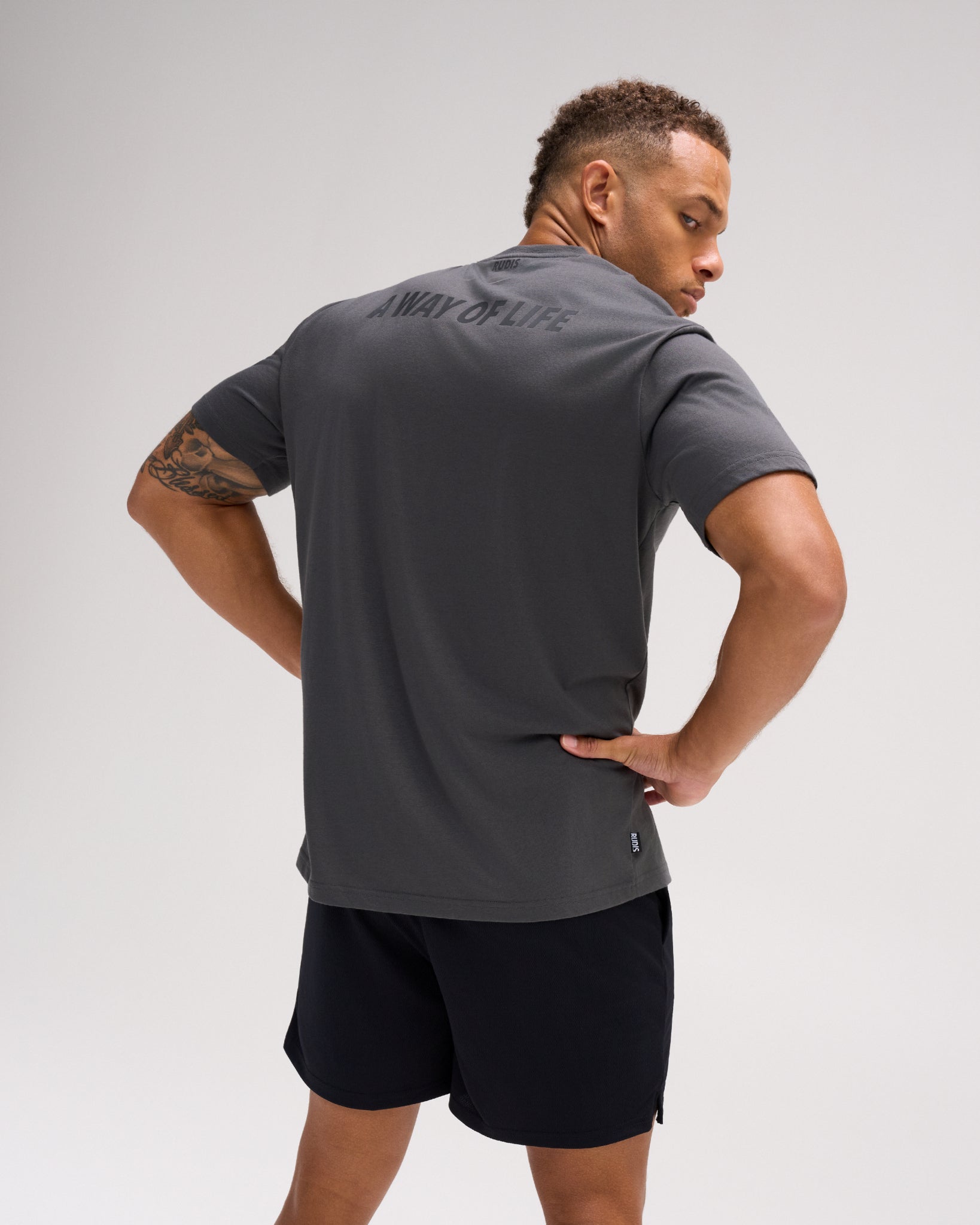 Back view of the charcoal RUDIS Script Elite Super Soft T-Shirt featuring tonal A WAY OF LIFE graphics across the upper back.