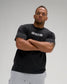 Front view of a model wearing the RUDIS Iron Sharpens Iron Classic Cotton T-Shirt in Washed Black, highlighting the white chest lettering, crew neckline and relaxed silhouette.