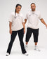 Male and female models wearing the RUDIS Wrestling Classic Cotton T-Shirt in Bone, featuring distressed black Wrestling lettering and a RUDIS Hex logo.