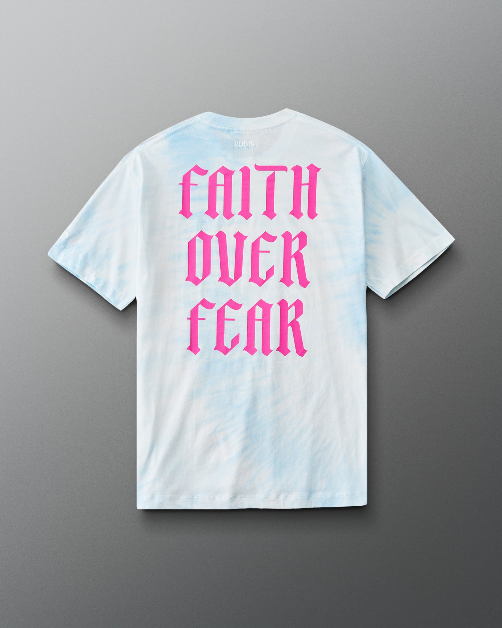 Back view of the RUDIS Faith Over Fear T-Shirt in Blue Tie Dye featuring oversized pink gothic Faith Over Fear lettering.