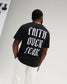 Male model wearing the RUDIS Faith Over Fear Classic Cotton T-Shirt in Washed Black, featuring large white gothic Faith Over Fear lettering across the back.