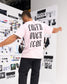 Male model wearing the RUDIS Faith Over Fear Classic Cotton T-Shirt in Washed Pink, showcasing oversized black Faith Over Fear lettering on the back.