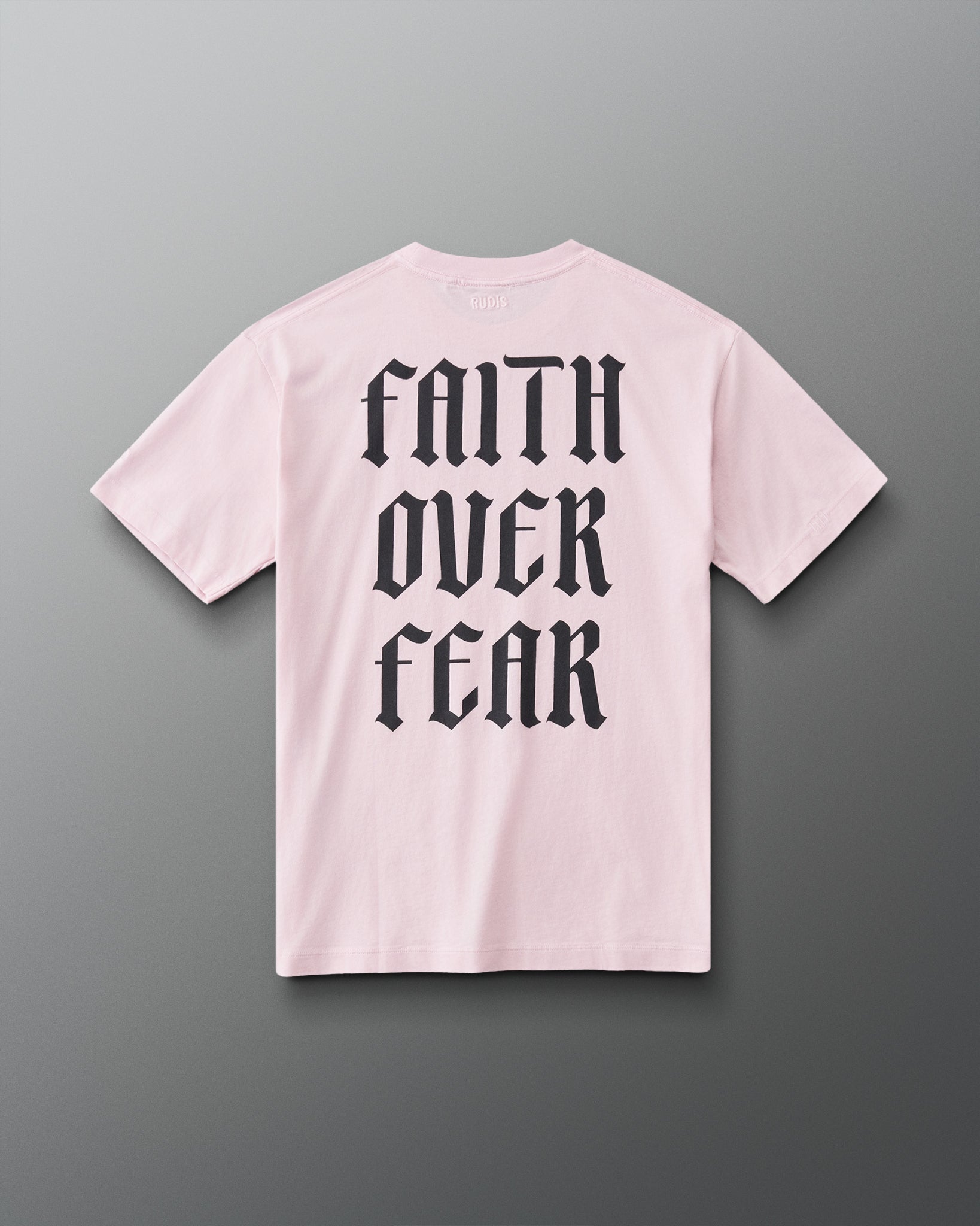 Back view of the RUDIS Faith Over Fear T-Shirt in Washed Pink featuring bold black gothic Faith Over Fear back lettering.