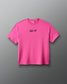 A bright pink short-sleeve crewneck t-shirt with the words 'ALL IN' printed in black script across the chest, displayed against a dark gray gradient background.