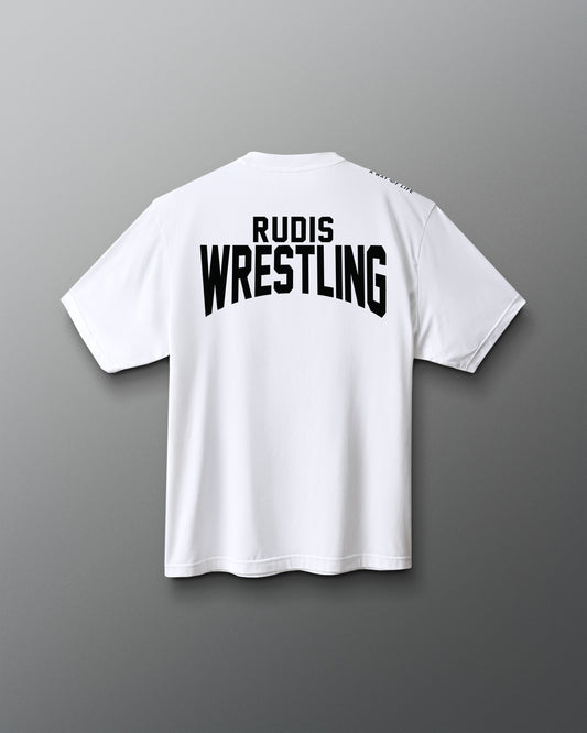 A white short-sleeve t-shirt shown from the back, featuring the words 'RUDIS WRESTLING' printed in bold black letters across the upper back, set against a dark gray gradient background.