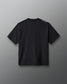 A black short-sleeve t-shirt shown from the back, featuring a small white text print on the left shoulder, displayed against a neutral gray background.