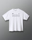 A white short-sleeve crewneck t-shirt with 'RUDIS' printed across the chest in a thin black outline font, accompanied by small black logos on the left chest, shown against a dark gray gradient background.
