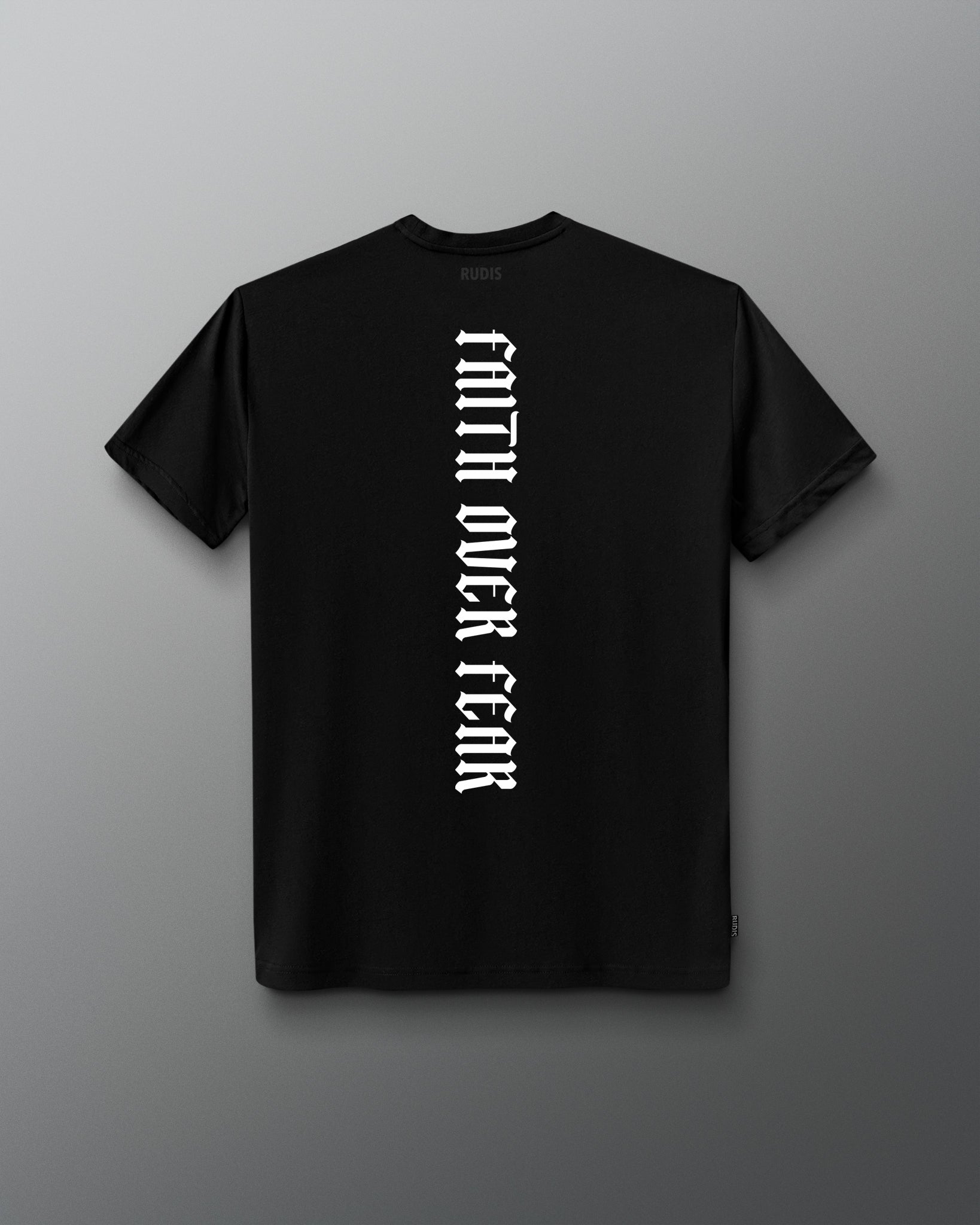 Back of the black RUDIS Cross Elite Super Soft T-Shirt featuring vertical white “Faith Over Fear” lettering and tonal RUDIS neck branding.