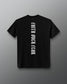 Back of the black RUDIS Cross Elite Super Soft T-Shirt featuring vertical white “Faith Over Fear” lettering and tonal RUDIS neck branding.