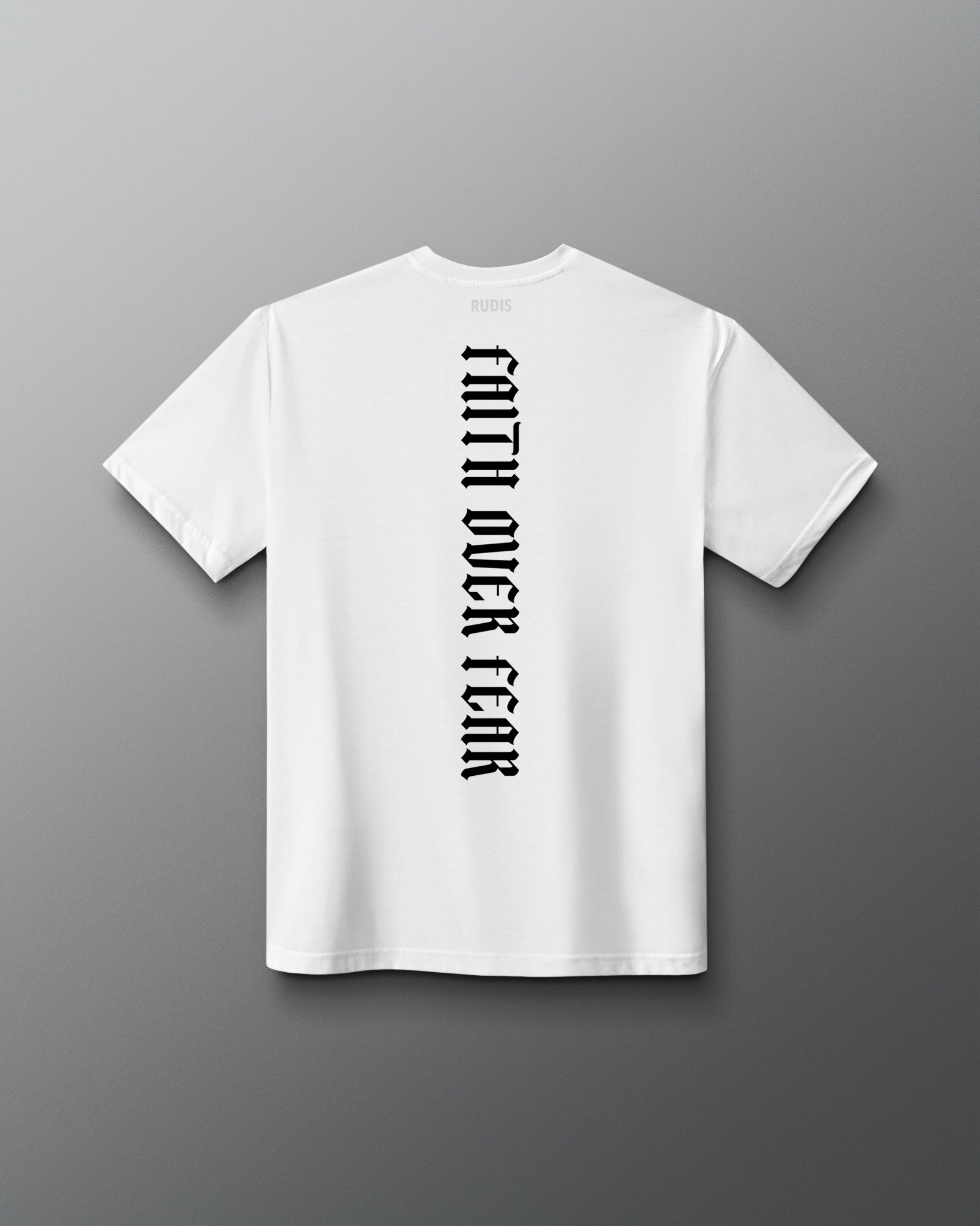 Back of the white RUDIS Cross Elite Super Soft T-Shirt featuring vertical black “Faith Over Fear” lettering and RUDIS neck branding.