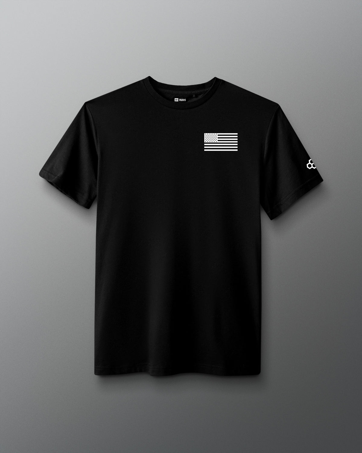 Black RUDIS Core Flag Elite Super Soft T-Shirt shown from the front, featuring a white American flag graphic on the chest and RUDIS mark on the sleeve.