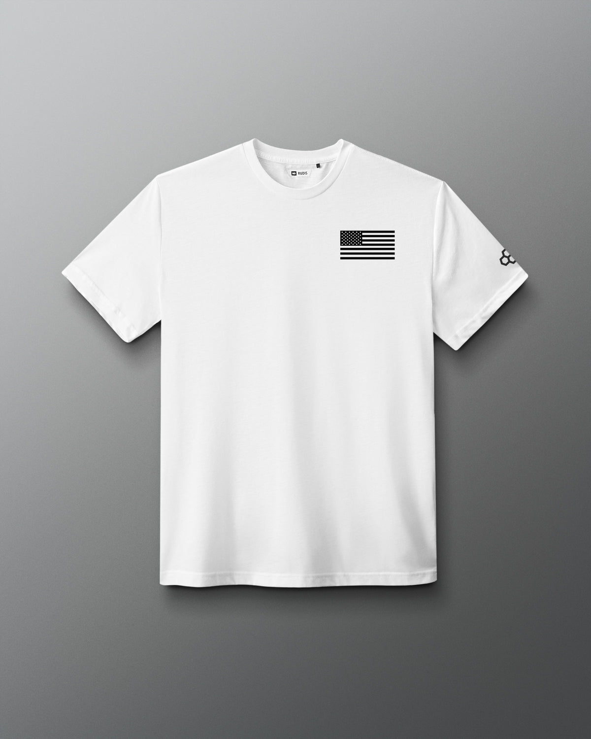 White RUDIS Core Flag Elite Super Soft T-Shirt shown from the front, featuring a black American flag graphic on the chest and contrasting RUDIS mark on the sleeve.