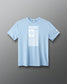 A light blue short-sleeve crewneck t-shirt with a white graphic print on the front reading 'RUDIS' above a vertical striped flag design, displayed on a neutral gray background.